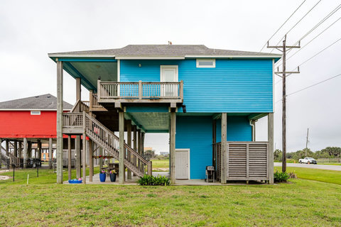 Stairs lead up from the yard to the side deck