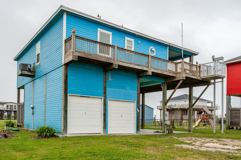 Bright blue beach house with parking out front