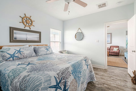 Primary bedroom with a king bed and plenty of natural light