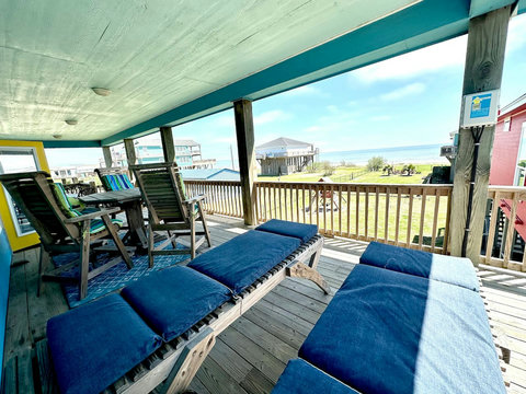 Covered deck with loungers and wide Gulf views