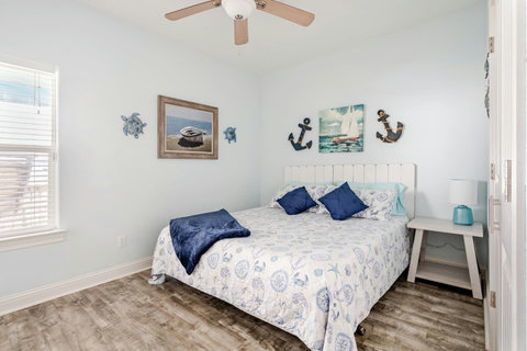 Second bedroom with a king bed and nautical decor