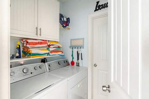 Laundry room with washer, dryer and beach towels