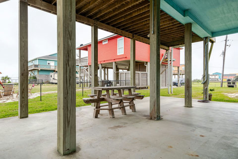 Shaded patio under the house with picnic tables
