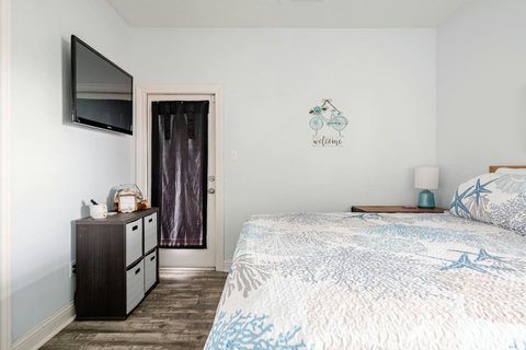 Primary bedroom with a wall-mounted TV
