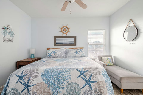 Primary bedroom: king bed and a chaise for reading