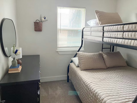 Bunk room with a dresser