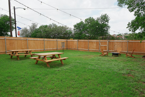 Big fenced backyard with picnic tables