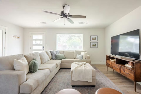 Sectional and TV with the front door nearby