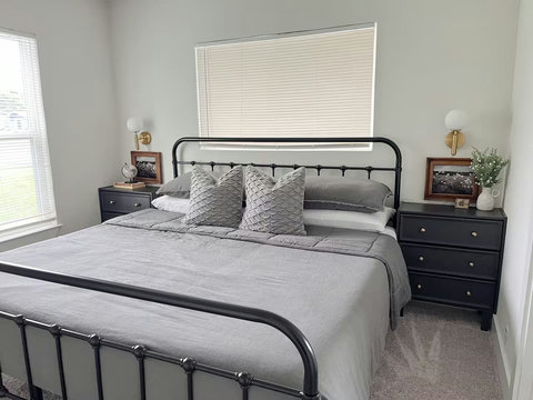 King bed with brass sconces