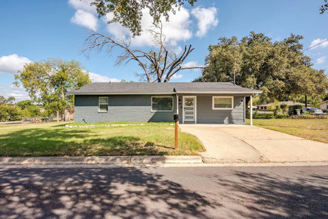 Single-story home under big shade trees