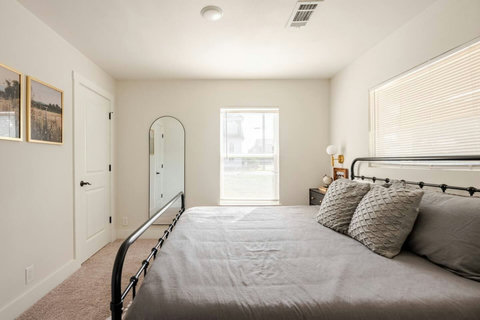 King bedroom with a floor mirror