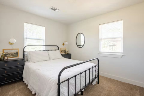 Queen bedroom with a white iron bed