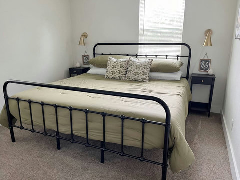 Bedroom with brass sconces