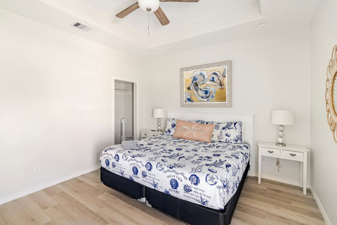 King bedroom with crisp coastal bedding