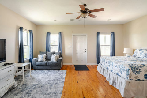 King bedroom with a loveseat and TV