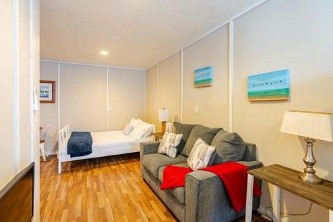 Bunk room with a full bed and sofa