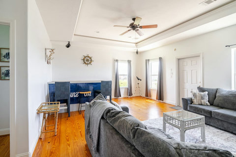 Upstairs lounge with sofas and a game table