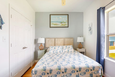 Queen bedroom with coastal art