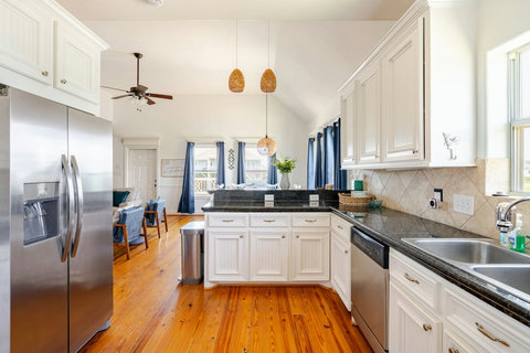 Kitchen with granite counters and a stainless fridge