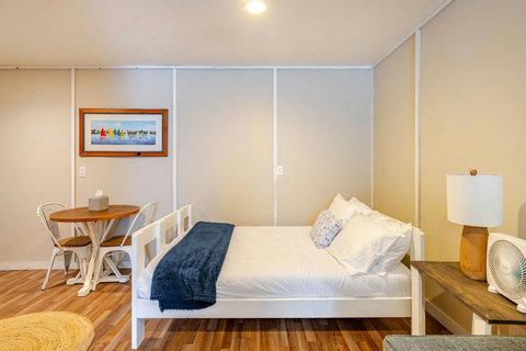 Full bed and a small dining table