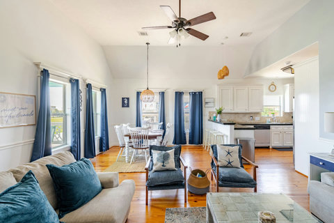 Bright main living room with pine floors and plenty of seating
