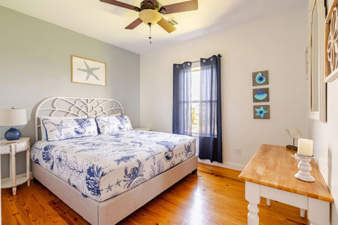 King bedroom with a white headboard and desk