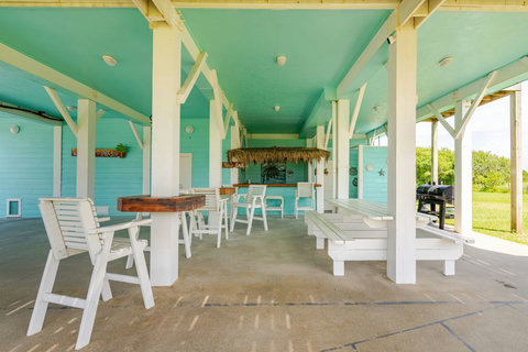 Covered patio with picnic tables and the tiki bar