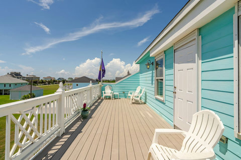 Long covered deck with Adirondack chairs