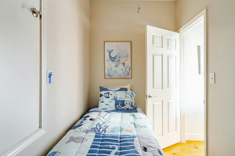 Twin bed with ocean-themed bedding