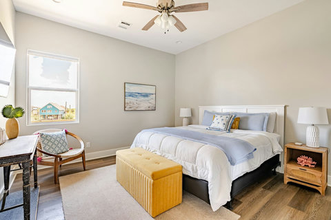 King bedroom with a reading chair