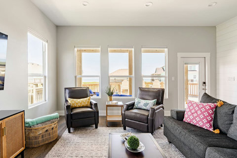 Recliners and a sectional by the windows