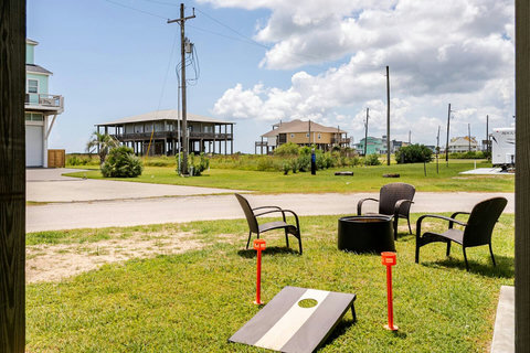 Fire pit and cornhole in the yard