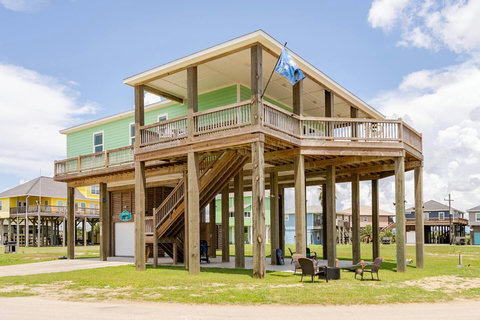 Mint-green beach house with a big covered deck