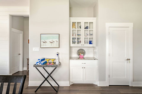Glass-front cabinets and a bar cart