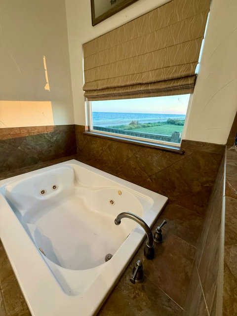 Soak in the tub with a view of the water