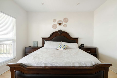 Primary bedroom: king bed and a carved headboard