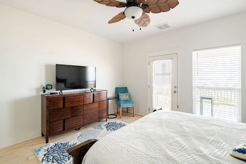 Smart TV and dresser in the primary bedroom