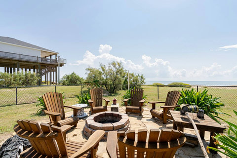 Fire pit with Adirondack chairs and a Gulf view