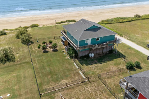 Right on the sand, with a fenced yard and fire pit