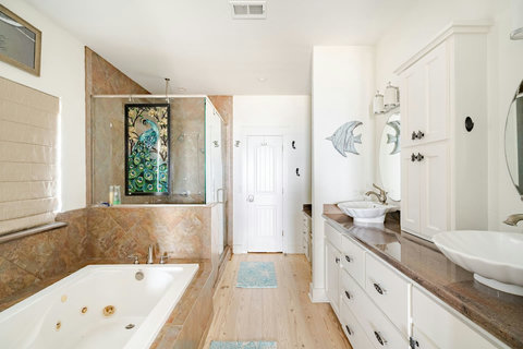 Primary bath with a jetted soaking tub and walk-in shower