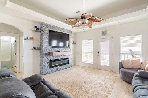 Living room with a stone electric fireplace and big smart TV