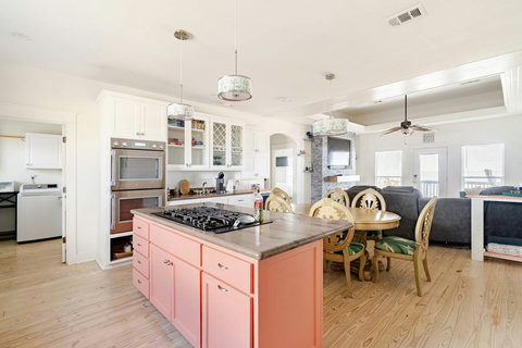 Kitchen island with a gas cooktop, open to the living room