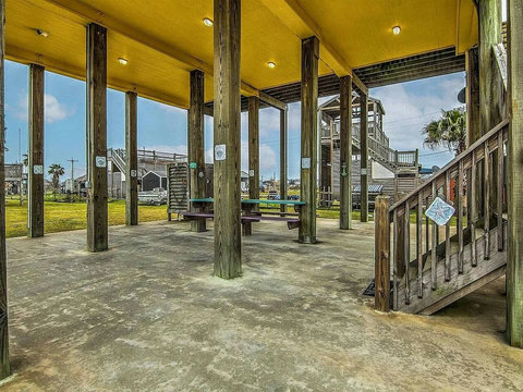 Big shaded patio with stairs to the deck