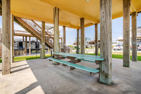 Picnic tables in the shade under the house