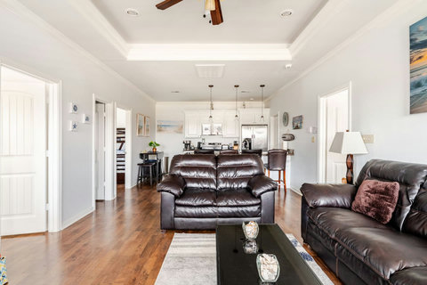Living room with leather sofas, open to the kitchen