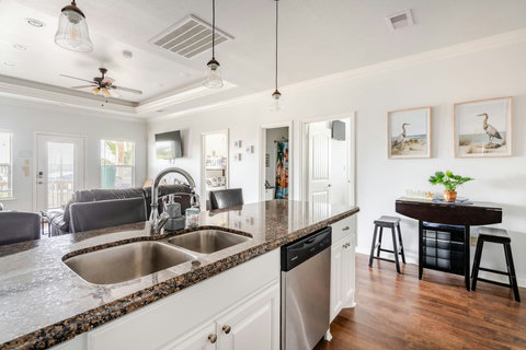 Kitchen sink with views of the living room