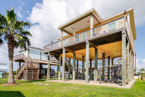 Raised beach house with a covered patio below