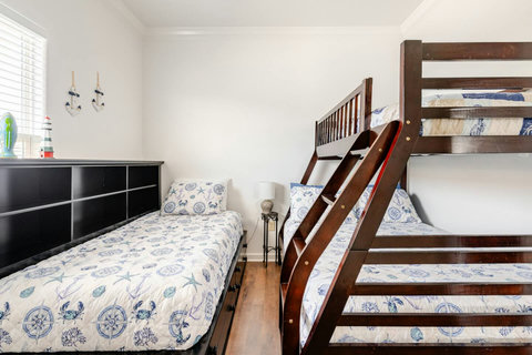 Daybed and bunk with coastal bedding