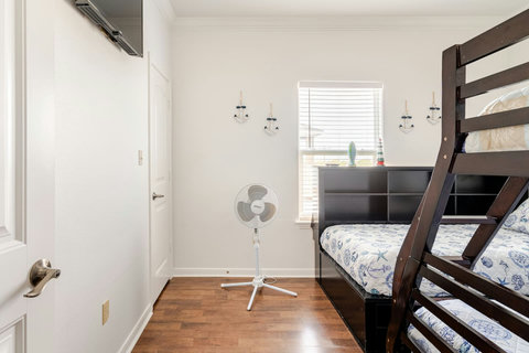 Bunk room with a storage headboard