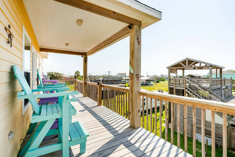 Covered deck with tall Adirondack chairs and a breeze